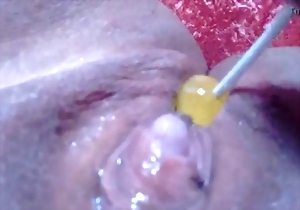 Sweet girl shoves a yellow candy in her little pussy