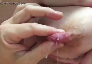 A stunning model with gorgeous big tits squeezes her hard nipples